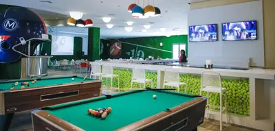a billiard room with a pool table and a bar at Majestic Mirage Punta Cana, All Suites – All Inclusive in Punta Cana