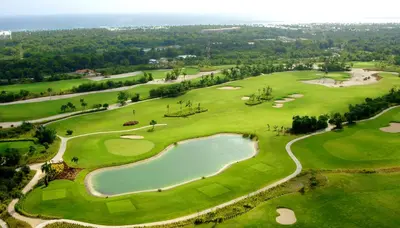 an aerial view of a golf course with a pond at Majestic Mirage Punta Cana, All Suites – All Inclusive in Punta Cana