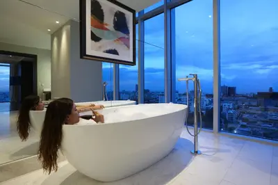 a large white bath tub in a bathroom with a window at InterContinental Real Santo Domingo by IHG in Santo Domingo