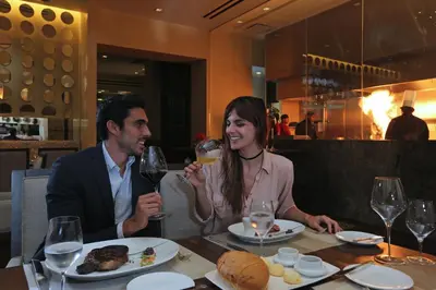 a man and woman sitting at a table with wine glasses at InterContinental Real Santo Domingo by IHG in Santo Domingo