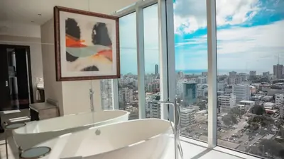 a bathroom with a white tub and a large window at InterContinental Real Santo Domingo by IHG in Santo Domingo