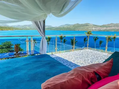 a bedroom with a view of the ocean at Sunset Samana in Las Galeras