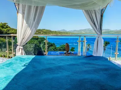 a bedroom with a view of the ocean at Sunset Samana in Las Galeras