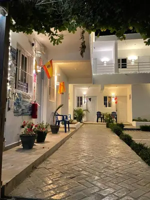 a walkway leading to the front of a building at Albergo El Pulpo, Bayahíbe in Bayahibe