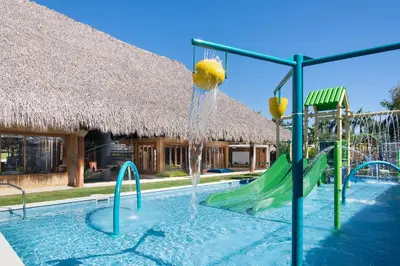 a pool with a water slide in a resort at Dreams Onyx Resort & Spa - All Inclusive in Punta Cana