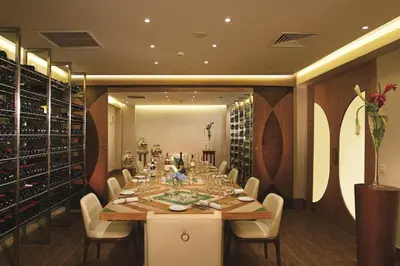 a dining room with a long table and white chairs at Dreams Onyx Resort & Spa - All Inclusive in Punta Cana