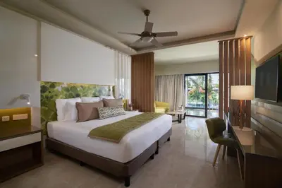 a hotel room with a bed and a television at Dreams Onyx Resort & Spa - All Inclusive in Punta Cana