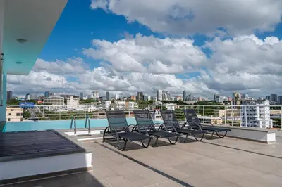 a group of chairs sitting on the roof of a building at Lincoln Suite in Santo Domingo