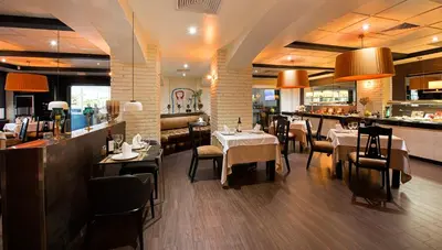 a restaurant with tables and chairs and a bar at W&P Santo Domingo in Santo Domingo