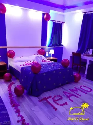 a bedroom with a bed with red decorations on the floor at Hotel El Dorado in La Romana
