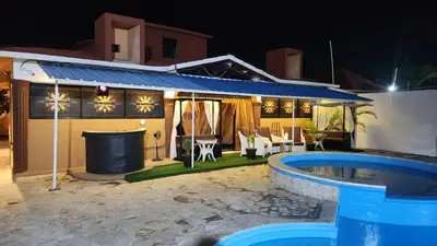 a house with a swimming pool at night at Hotel El Dorado in La Romana
