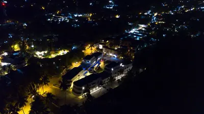 a view of a city at night with lights at Puerto Plaza Las Terrenas in Las Terrenas