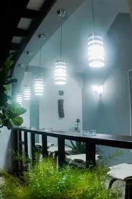 a dining room with a table and lights at Hotel Casa Jum in Santiago de los Caballeros