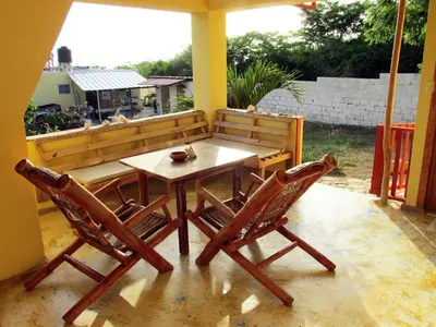 a wooden table and two chairs on a patio at Corales Punta Rusia in Punta Rucia