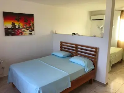 a bedroom with a bed and a mirror on the wall at Corales Punta Rusia in Punta Rucia