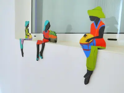 three figurines of women sitting on a counter at Villa Salamandra in Las Galeras