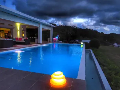 a swimming pool in front of a house at night at Villa Salamandra in Las Galeras