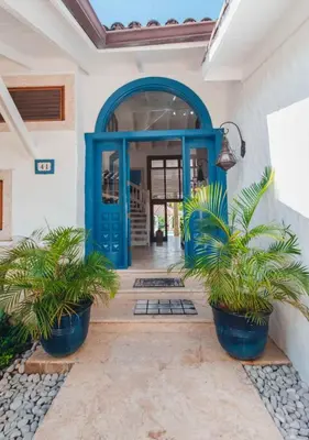 a blue front door of a house with potted plants at Villa Maud in La Romana