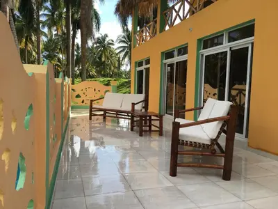 a patio with rocking chairs on a house at Casa Altea in Santa Bárbara de Samaná