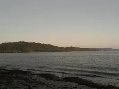 a large body of water with a mountain in the distance at Casa Altea in Santa Bárbara de Samaná