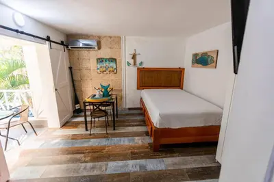 a small bedroom with a bed and a table at Amazing Apartments, A-Juan Dolio, El Bonito II in Juan Dolio