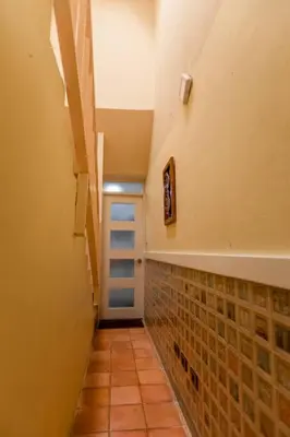 a hallway with a tile floor and a blue door at Amazing Apartments, A-Juan Dolio, El Bonito II in Juan Dolio