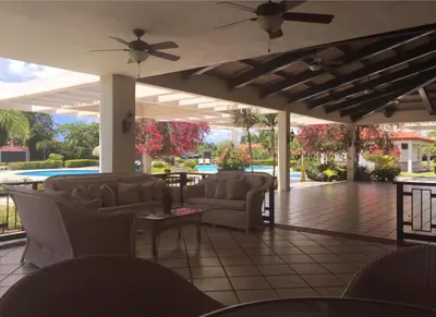 a patio with couches and a table and a ceiling at Villamorametro in Juan Dolio