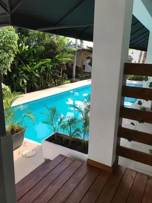 a view of a swimming pool from a patio with a wooden deck at Centro de Santiago in Santiago de los Caballeros