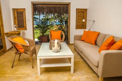 a living room with a couch and a table at Jasmine La Playita - Ocean Front in Las Galeras