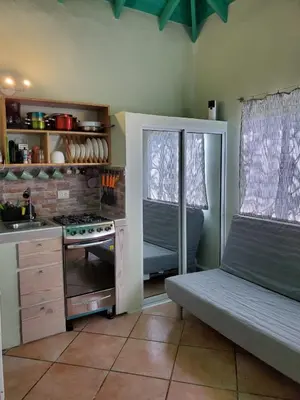 a kitchen with a bench and a stove in it at Casa Barbara in Las Terrenas