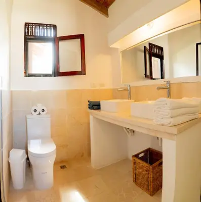 a bathroom with a toilet and a sink and mirror at Villa Diana in Las Galeras