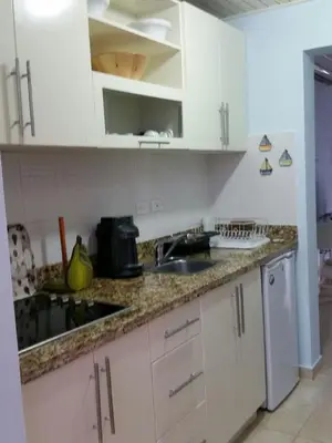 a kitchen with white cabinets and a sink at Appartamento Vista Mare in Bayahibe