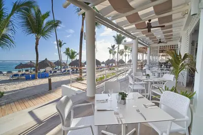 a restaurant with a view of the beach at Bahia Principe Grand Aquamarine - Adults Only All Inclusive in Punta Cana