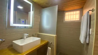 a bathroom with a white sink and a window at Hotel Don Andres in Sosúa