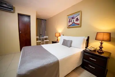 a hotel room with a bed and a telephone at Hotel Real Bella Vista in Santo Domingo