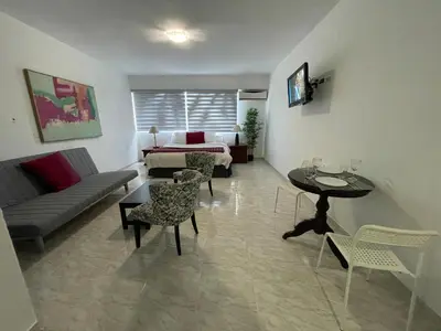 a living room with a couch and a table at Hotel Real Bella Vista in Santo Domingo