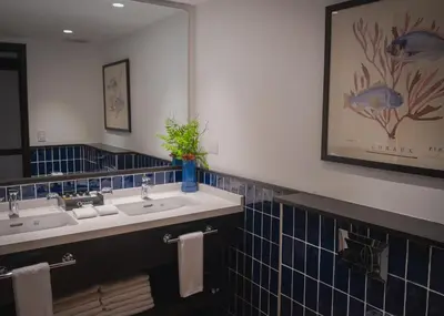 a bathroom with two sinks and a large mirror at Ocean Blue & Sand Beach Resort - All Inclusive in Punta Cana