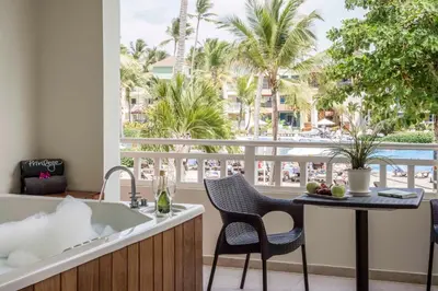 a kitchen with a tub and a table with chairs at Ocean Blue & Sand Beach Resort - All Inclusive in Punta Cana