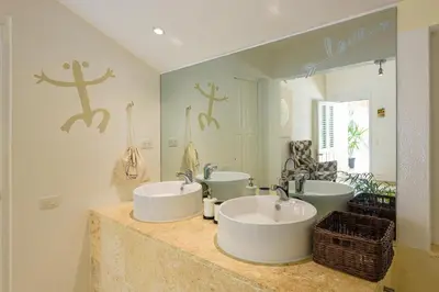 a bathroom with two sinks and a large mirror at Adults-Only Hacienda Terra Taina in Las Terrenas