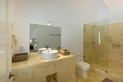 a bathroom with a sink and a shower and a toilet at Adults-Only Hacienda Terra Taina in Las Terrenas