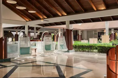 a group of chairs sitting in a lobby at Grand Palladium Palace Resort Spa & Casino - All Inclusive in Punta Cana