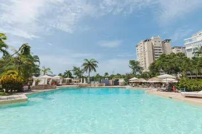 a large pool with blue water in a resort at Dominican Fiesta Hotel in Santo Domingo