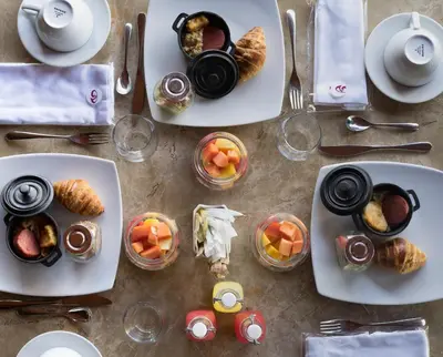 a table topped with plates of food and bowls of food at Dominican Fiesta Hotel in Santo Domingo
