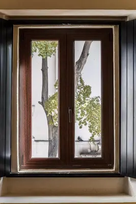a window with a tree seen through it at Hodelpa Nicolás de Ovando in Santo Domingo