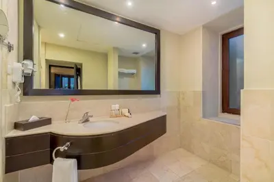 a bathroom with a sink and a large mirror at Hodelpa Nicolás de Ovando in Santo Domingo