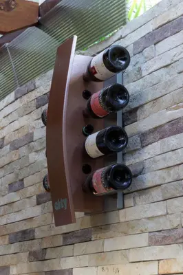 a bunch of wine bottles on the side of a wall at Casa Valeria Boutique Hotel in Sosúa