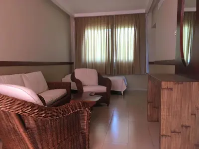 a living room with chairs and a couch and a television at VIK hotel Arena Blanca in Punta Cana