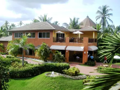 a house with a courtyard and palm trees at VIK Hotel Cayena Beach All Inclusive in Punta Cana