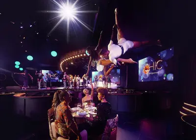 a group of people sitting at a table in a dance performance at TRS Turquesa Hotel - Adults Only - All Inclusive in Punta Cana