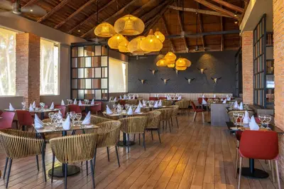 a dining room with tables and chairs and chandeliers at Grand Bavaro Princess - All Inclusive in Punta Cana